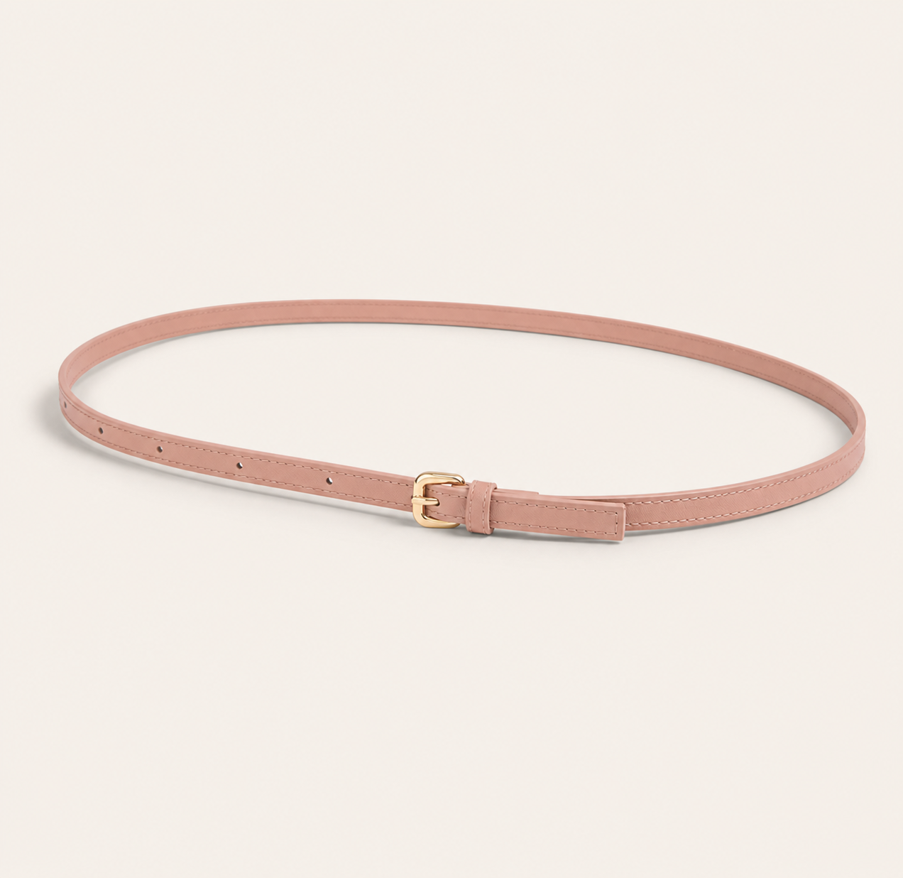 Pink belt with a gold buckle on a light background