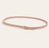 Pink belt with a gold buckle on a light background