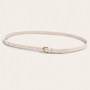 Thin ivory belt with a gold buckle on a light beige background