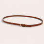 Brown belt with a gold buckle on a beige background