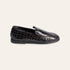 A single dark brown crocodile-embossed leather loafer shown in a side profile on a light beige background.