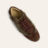A single brown suede and shearling slip-on sneaker with matching brown laces, shown from a top-down angle on a light cream background.