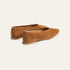 A pair of tan suede flat shoes with pointed toes, shown from a three-quarters angle on a light cream background.