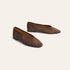 A pair of women's pointed-toe flats in dark brown suede, shown from a three-quarters angle on a light cream background.